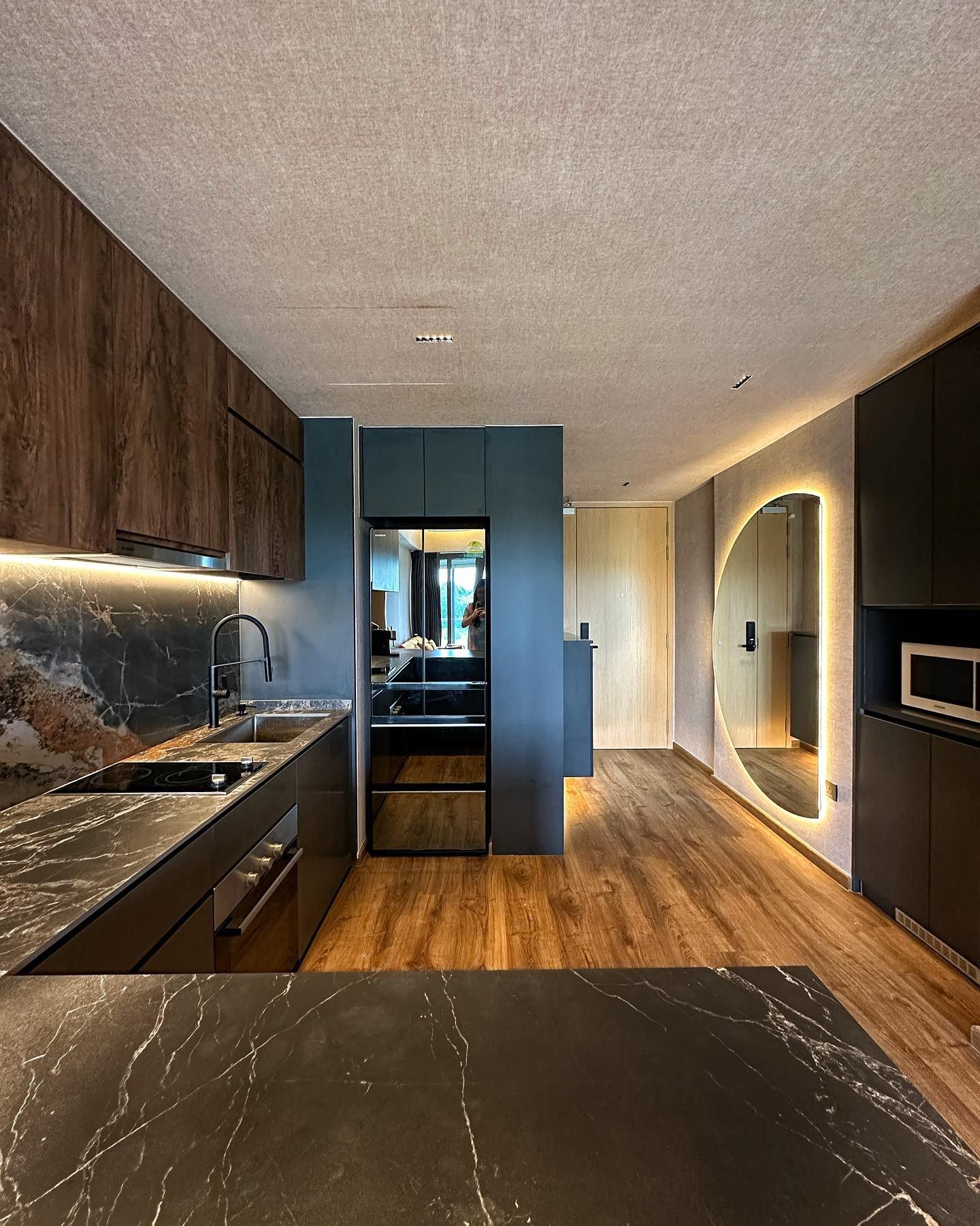 Dark walnut and navy condo kitchen