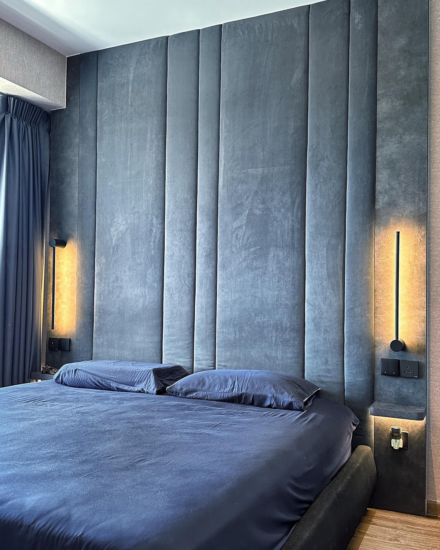 Dark walnut and navy condo bedroom